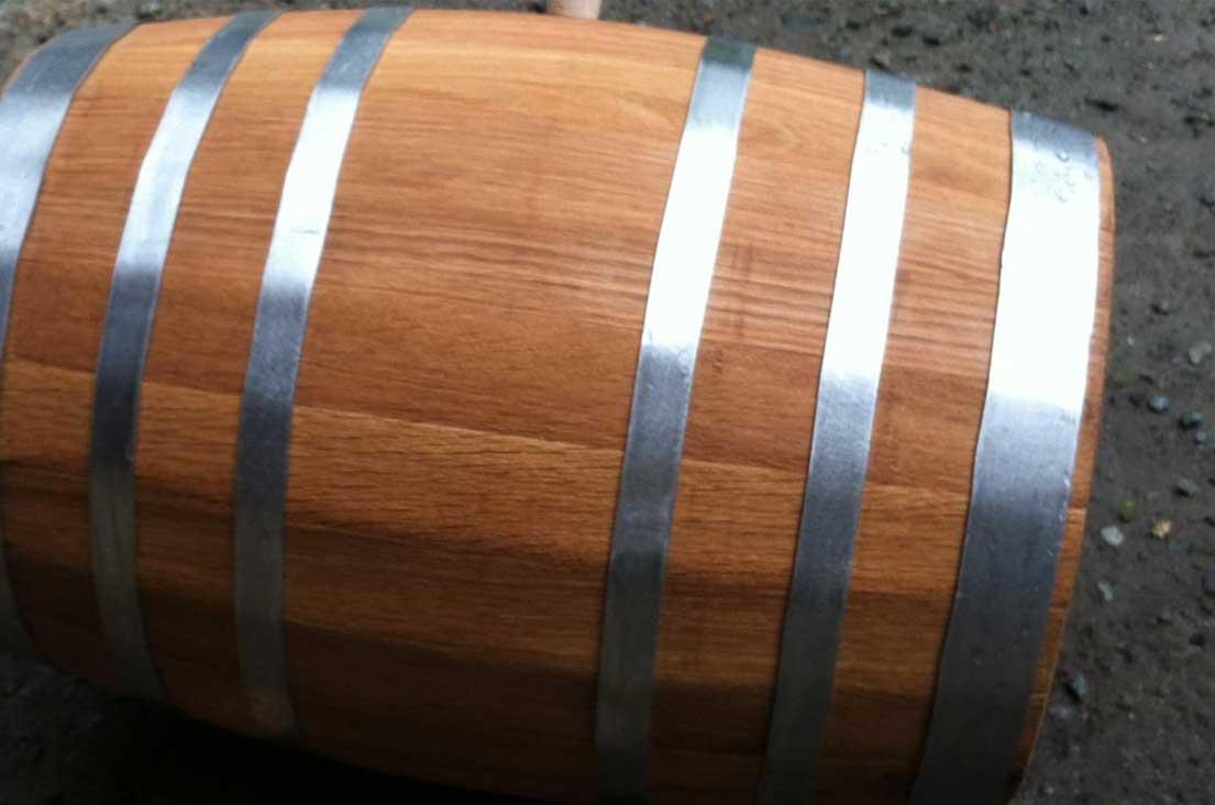 Cooper shaping a wooden barrel